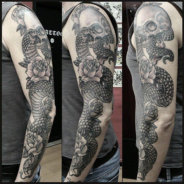 In black and gray tattoo of a snake by Marco Biondi TattooNOW